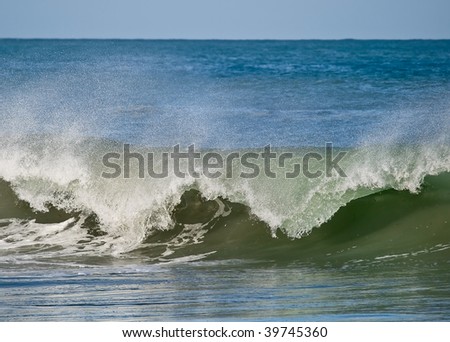 Front view of a breaking wave. The movement has been frozen using a fast shutter speed