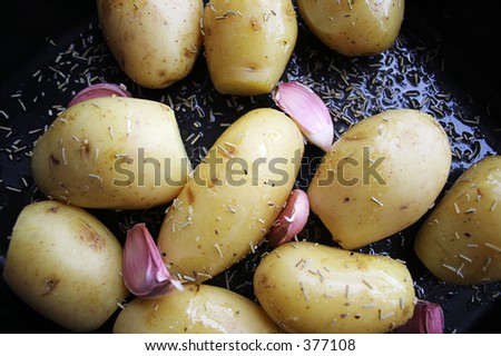 Potatoes ready to roast with olive oil, garlic and rosemary