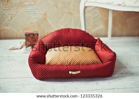 Red pet bed with white sofa in provance style in home interior