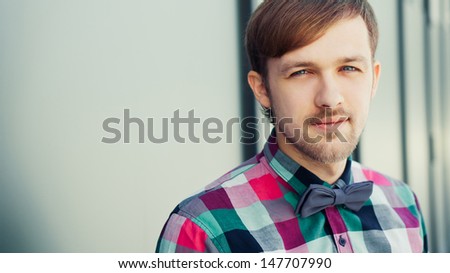 Fashion young man in formal shirt with bowtie