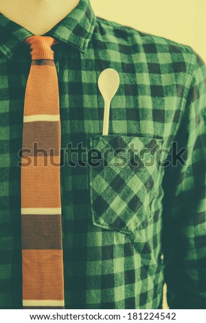 Retro man with tie and a white spoon in the pocket