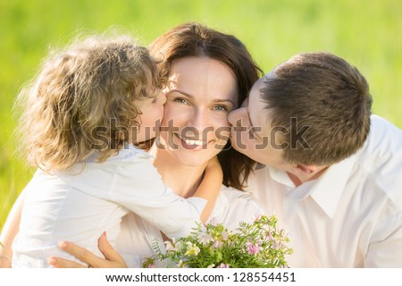 Happy family having fun outdoors in spring green field