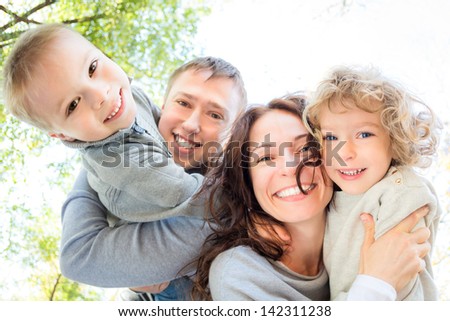 Low angle view of happy family in autumn park