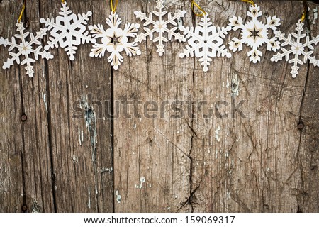 Snowflakes border on grunge wooden background. Winter holidays concept