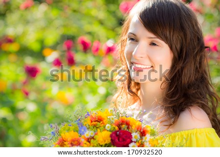Woman with bouquet of flowers against green background. Spring family holiday concept. Mother`s day