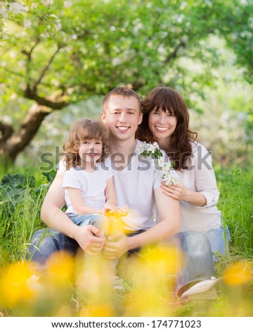 Happy family having fun outdoors in spring garden