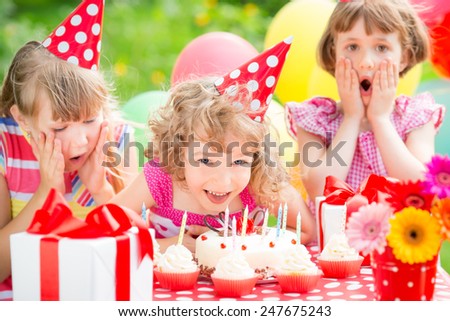 Group of happy children celebrating birthday Kids having fun in spring garden Group of happy children celebrating birthday Kids having fun in spring garden