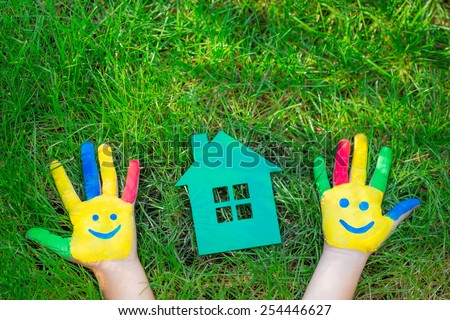 Group of happy people on green grass. Family having fun in spring. Smiley on hands. Ecology concept. Top view portrait