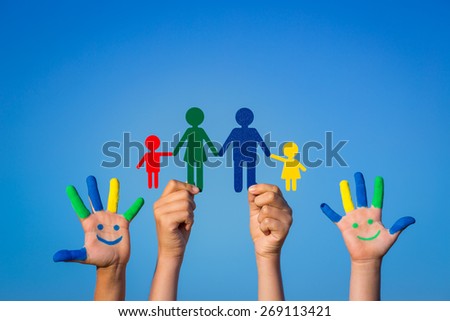 Happy family. Children with smiley on hands against blue summer sky background
