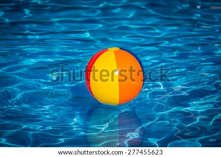 Beach ball in swimming pool. Summer vacation concept
