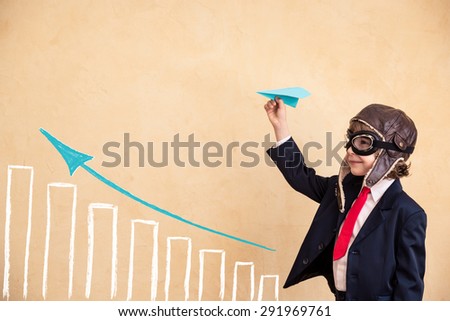 Portrait of young businessman with paper airplane. Success, creative and start up concept. Copy space for your text