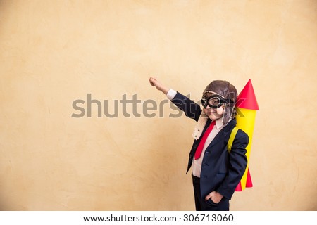 Portrait of young businessman with paper rocket. Success, creative and start up concept. Copy space for your text