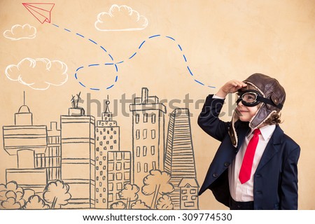 Portrait of young businessman with drawn airplane over city. Success, creative and start up concept