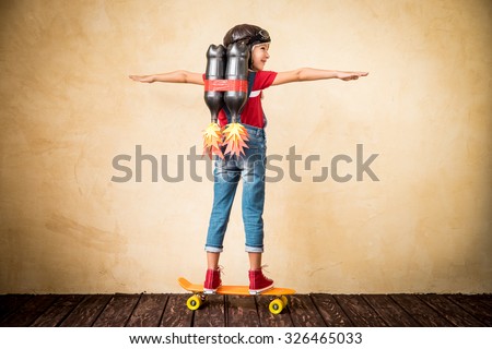 Kid with jet pack riding on skateboard. Child playing at home. Success, leader and winner concept