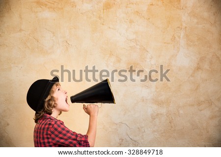 Kid shouting through vintage megaphone. Communication concept. Retro style