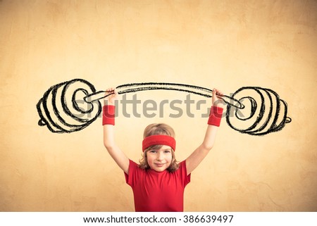 Funny strong child with drawn barbell. Girl power and feminism concept. Sport fitness kid