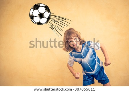 Child is pretending to be a soccer player. Success and winner concept