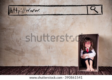 Portrait of child businessman in cardboard box. Think outside the box business concept. Internet security