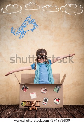 Child is pretending to be a pilot. Kid playing at home. Travel, freedom and imagination concept