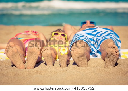 Happy family having fun on the beach. Summer vacation and travel concept