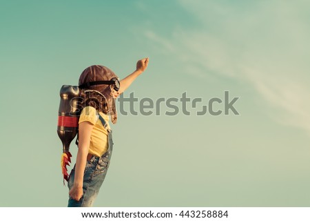 Kid with jetpack pretend to be superhero. Child playing in summer. Kid having fun outdoors. Portrait of child against summer sky background. Success, leader and winner concept. Imagination and freedom