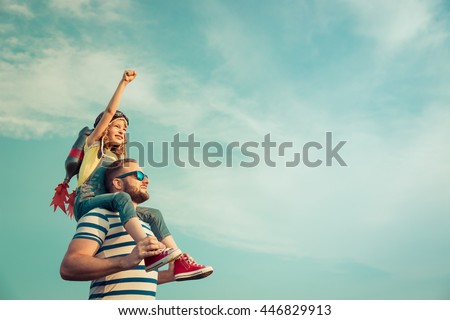 Kid with jet pack pretend to be superhero. Child playing with father in summer. Happy dad and son outdoors. Success, leader and winner concept
