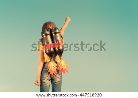 Kid with jet pack pretend to be superhero. Child playing in summer outdoors. Success, leader and winner concept