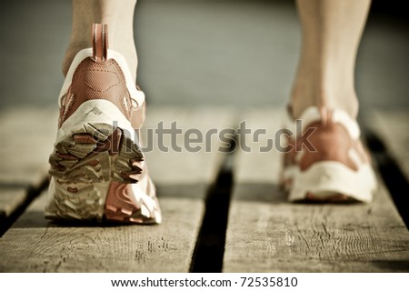 Feet of jogging man Vintage tinted image Feet of jogging man Vintage tinted image