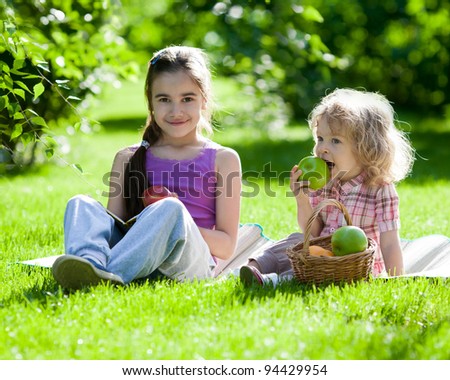 Happy children playing outdoors in spring park. Family picnic