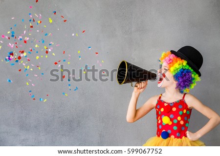 Let\'s party! Funny kid clown. Child speaking with megaphone. 1 April Fool\'s day concept