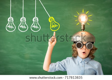 Portrait of child in classroom. Kid with toy virtual reality headset in class. Success, idea and creative concept. Back to school