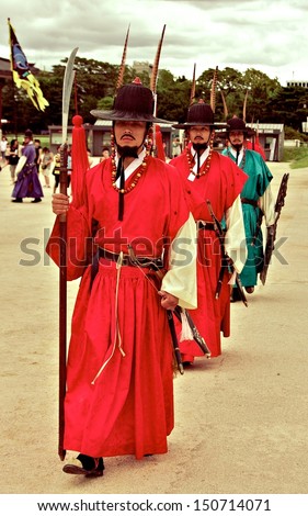 SEOUL - JULY 25: Royal guards holding swords during the changing of the guard ceremony at Gueongbokgung Palace July 25, 2009 in the Republic of Korea. This guard ceremony performs everyday.