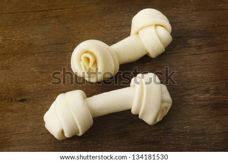 Artificial a bone for dog on wooden