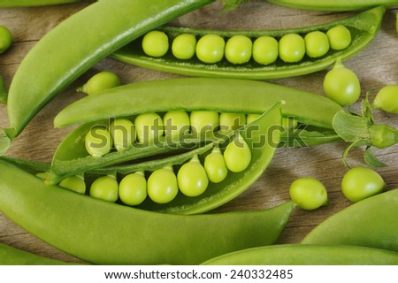 fresh sugar snap peas on wooden background