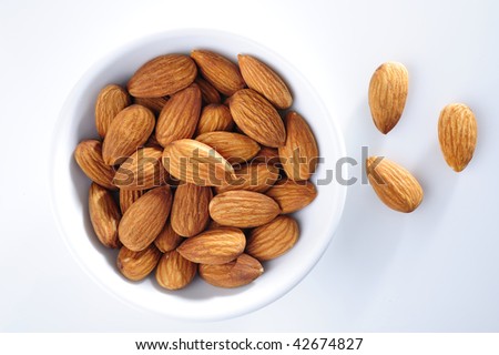 Almond in white cup on white background. top eye view.