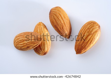 four almond seed on white background. macro, top eye view.