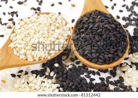 white sesame and black sesame on wood spoon