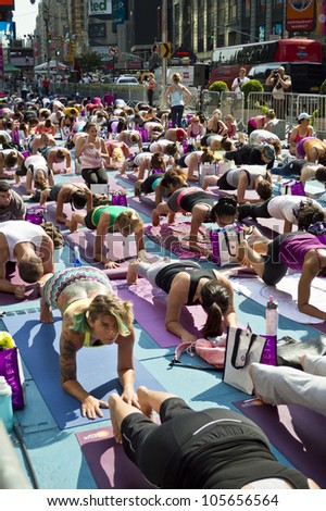 NEW YORK - JUNE 20: A heat wave in Manhattan on the first Day of Summer didn\'t stop the Yoga exercises in Times Square on June 20, 2012.