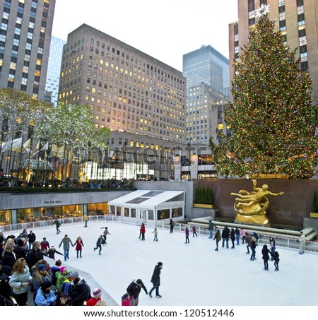 NEW YORK - NOVEMBER 30: Ice skaters and tourists are all around the famous Rockefeller Center Christmas tree on November 30, 2012 in New York City.