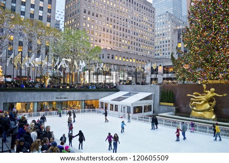 NEW YORK - NOVEMBER 30: Ice skaters and tourists are all around the famous Rockefeller Center Christmas tree on November 30, 2012 in  New York City.