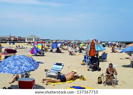 AVON, NEW JERSEY/USA - JULY 7: Big crowds of sunbathers seek relief from the week long heatwave enjoying the surf on July 7, 2012 at the beach in Avon NJ.