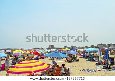 AVON, NEW JERSEY/USA - JULY 7: A sea of beach umbrellas on a hot  sunny day in Avon by the Sea along the Jersey shore on July 7, 2012 at the beach in Avon NJ.