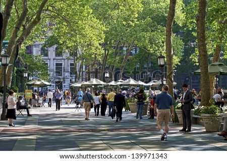 NEW YORK - MAY 21: A late afternoon view of on Bryant Park on May 21 2013 in Manhattan. Bryant Park is a popular 9.6 acre park located adjacent to The NY Public Library.