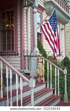 An old porch with an American flag in historic Clinton, New Jersey.