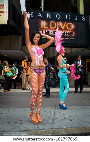 NEW YORK-SEPTEMBER 26: Two Pretty ladies in body paint look for tips from tourists with cameras in Times Square on September 26 2013 in Manhattan.
