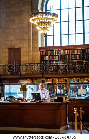 NEW YORK-APRIL 14: A libarian behind the desk at the New York City Public Library on April 14  2014 in Manhattan. The New York City Public Library is the second largest library in the United States.