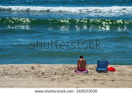 A girl enjoys quiet time on the beach on Long Beach Island in New Jersey.
