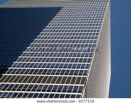 This is a shot of a section of a tall New York city building showing an interesting pattern of windows.