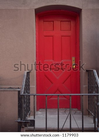 This is a study of a red door on a apartment building in Manhattan.