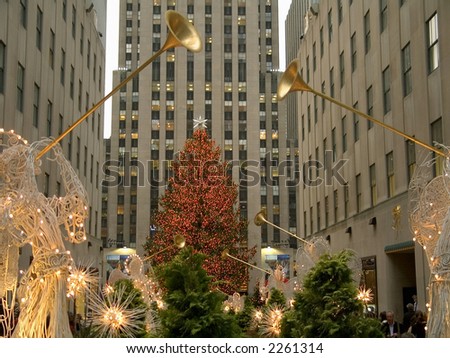 An angel decoration and colorful lights frame the Christmas tree at Rockefeller Center in Manhattan.